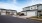 blue home with a garage and paved street in front